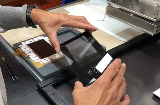 Frau kontrolliert bedruckte Glasscheibe