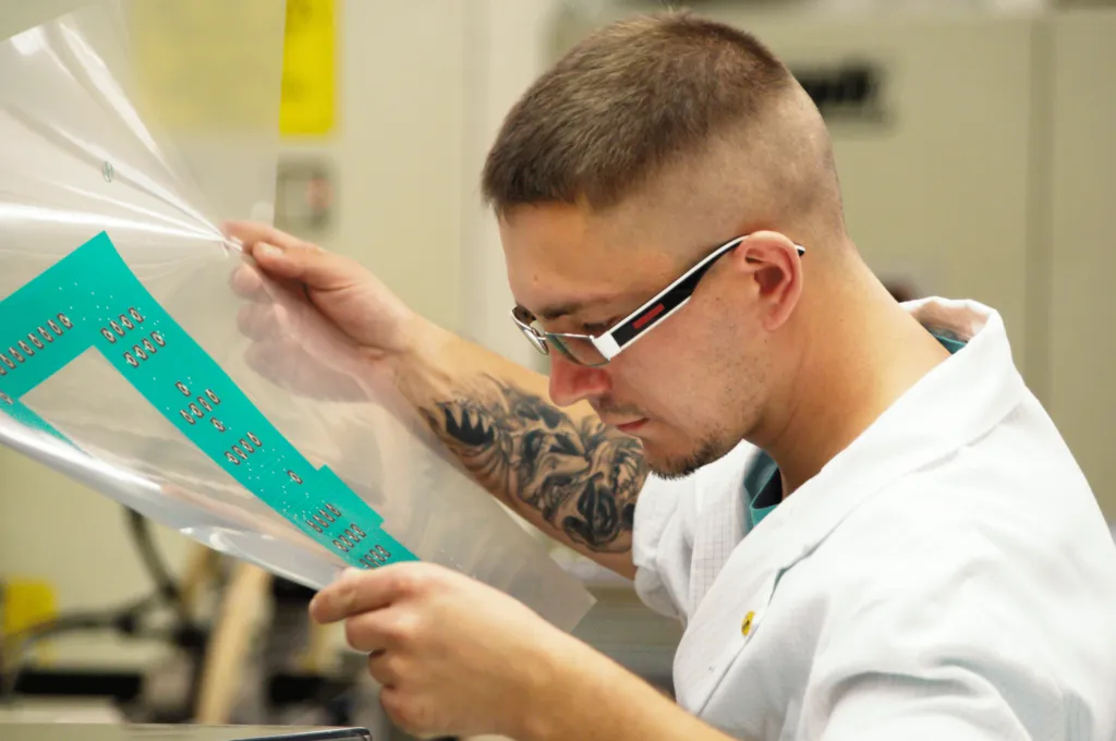 Mitarbeiter kontrolliert gedruckte Folie
